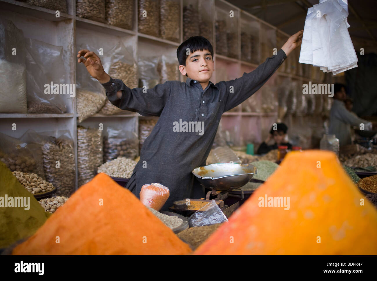 Child selling spices at the Itwar Bazar in Islamabad Stock Photo