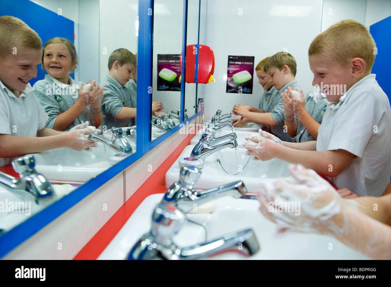 Children at a primary school wash their hands with soap in the sinks