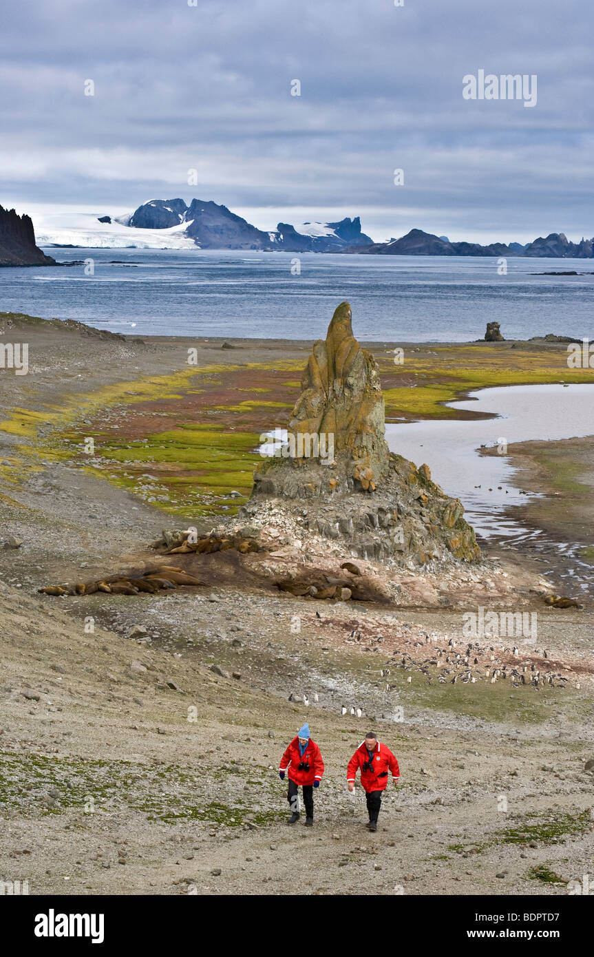 Couple exploring Aitcho Islands, Antarctica. Stock Photo