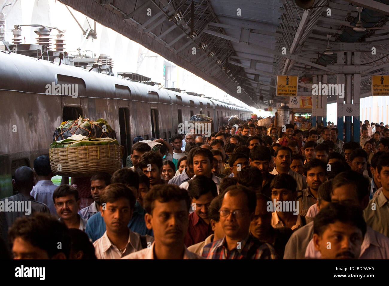 People Crowd the Platform to leave the Train at Sealdah Railway Station in Calcutta India Stock Photo