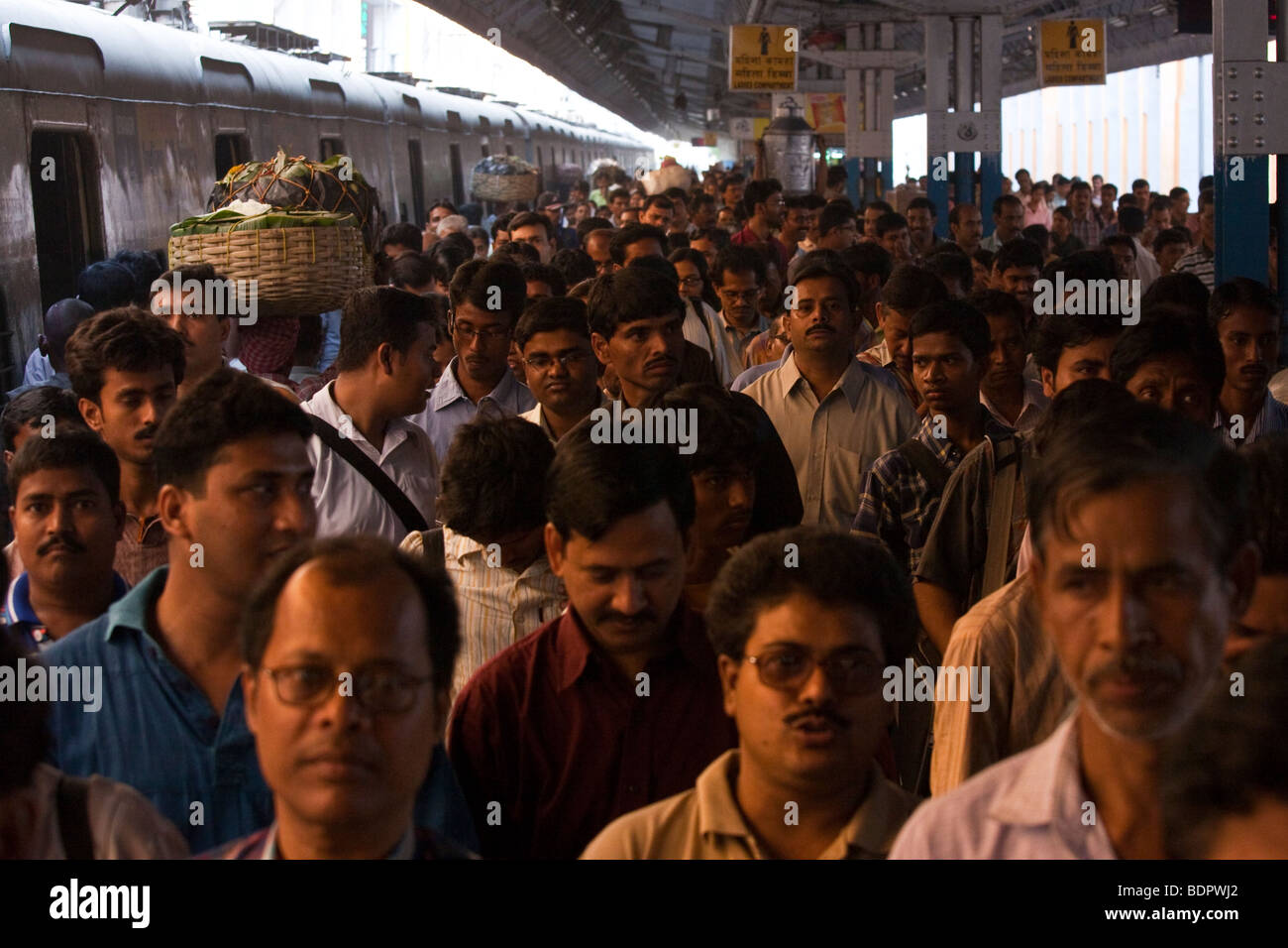 People Crowd the Platform to leave the Train at Sealdah Railway Station in Calcutta India Stock Photo