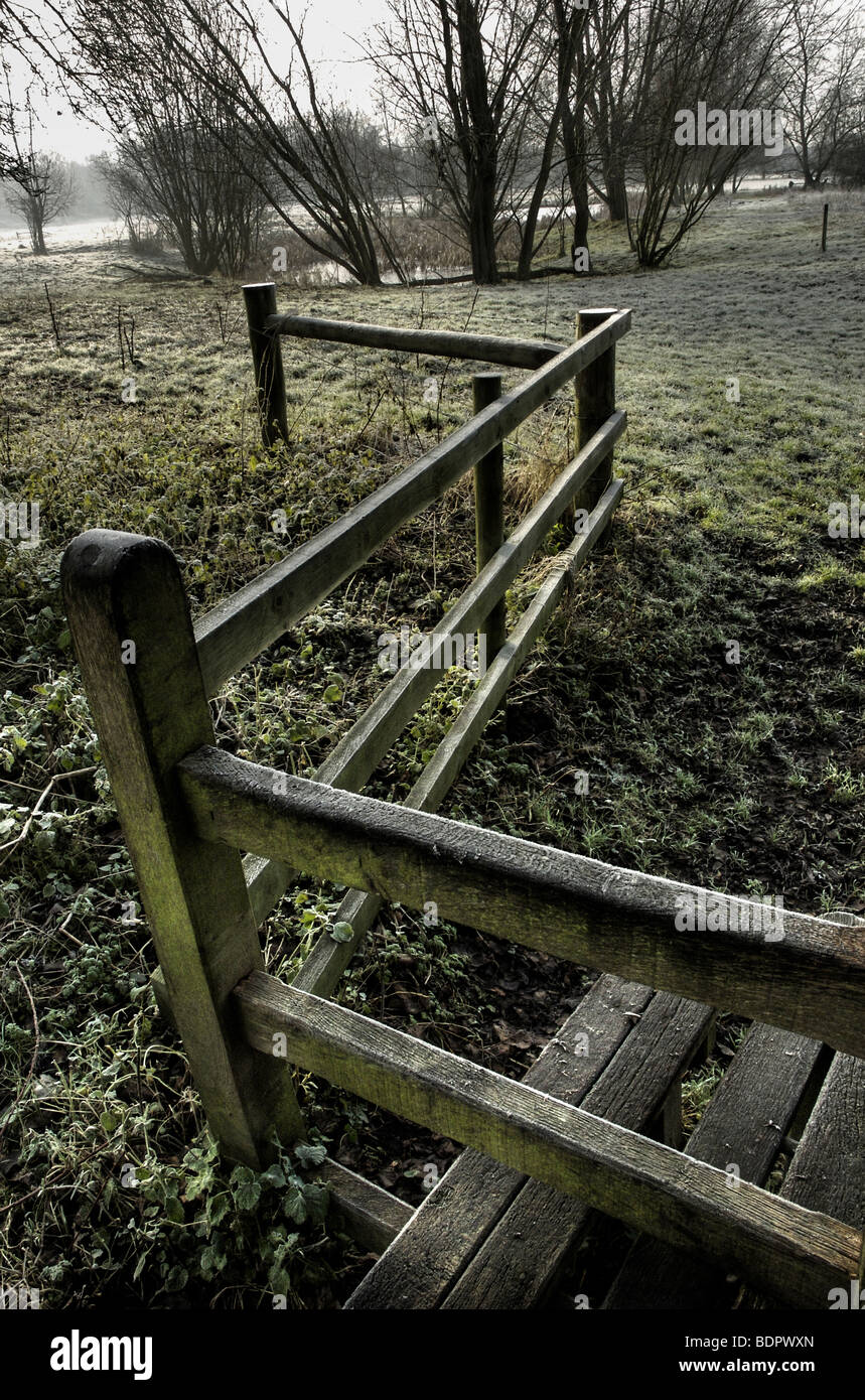 A crooked fence and stile at Thornham walks in Suffolk Stock Photo
