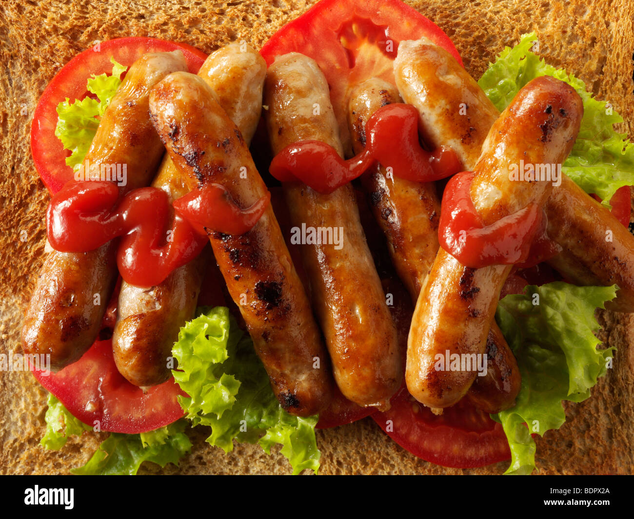 Traditional chipolatta pork sausages with tomato ketchup Stock Photo