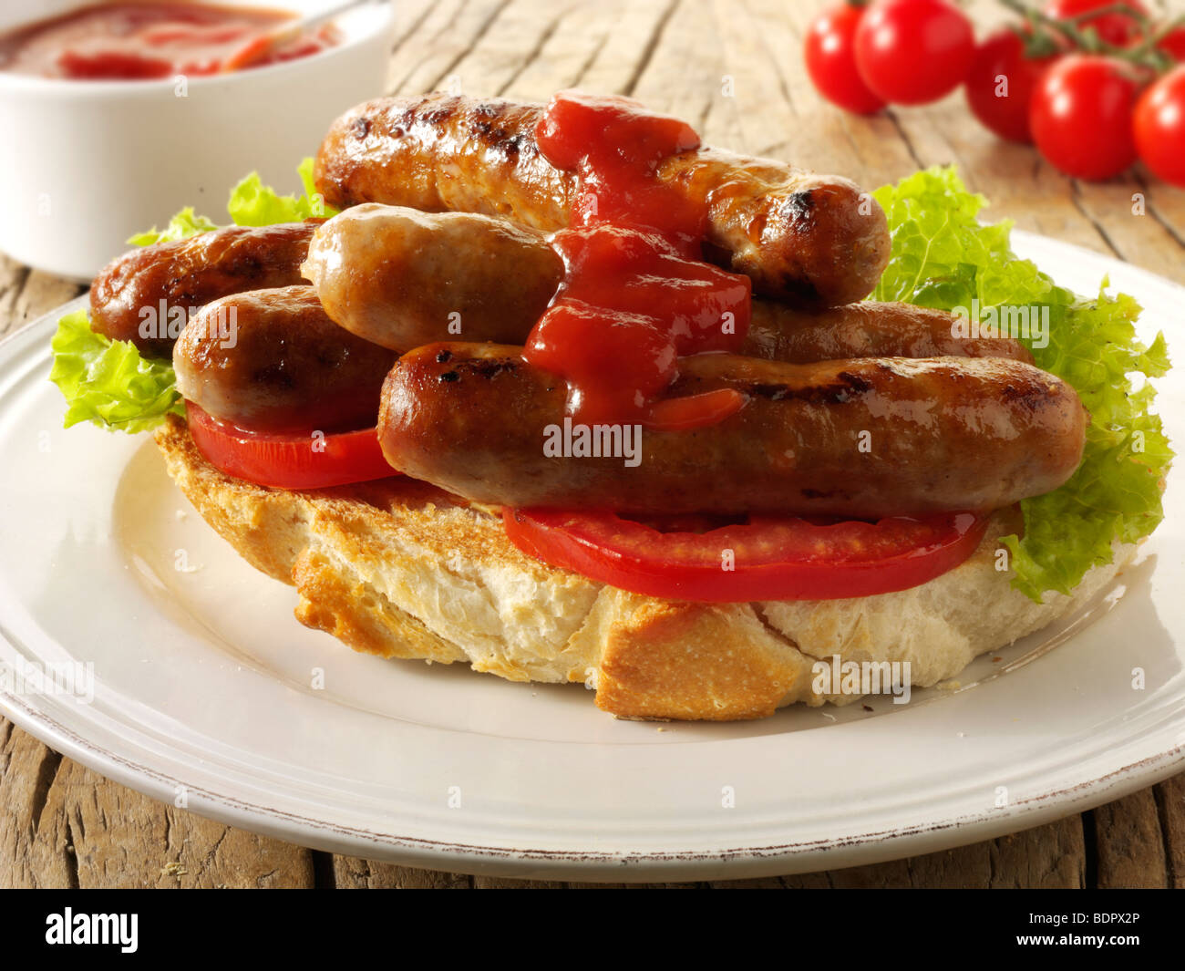 Traditional chipolatta pork sausages with tomato ketchup sandwich Stock Photo