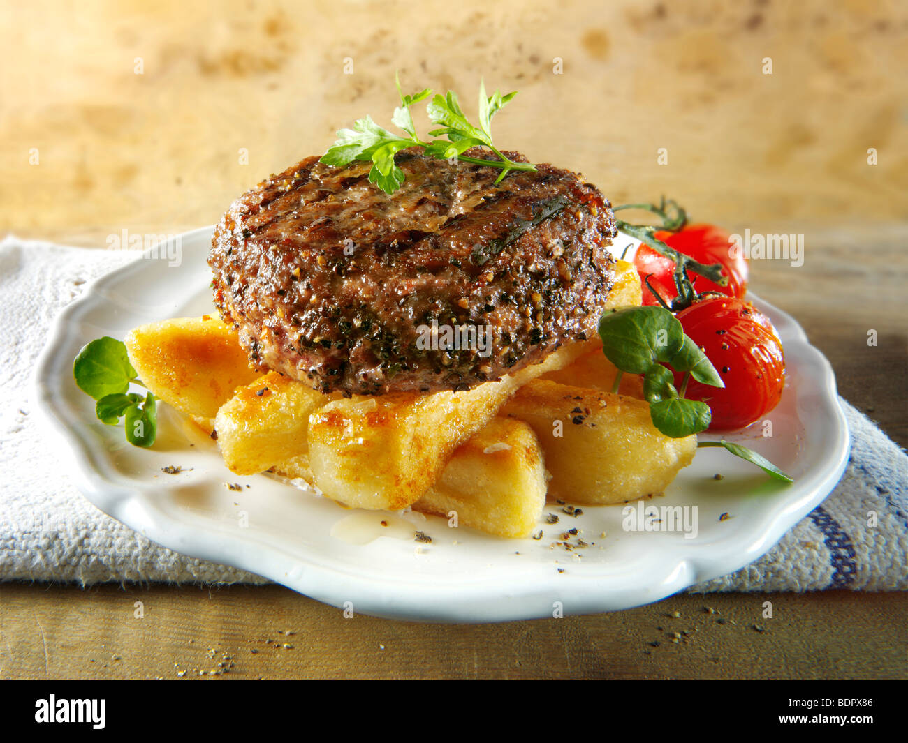 Peppered beef burger with chips Stock Photo