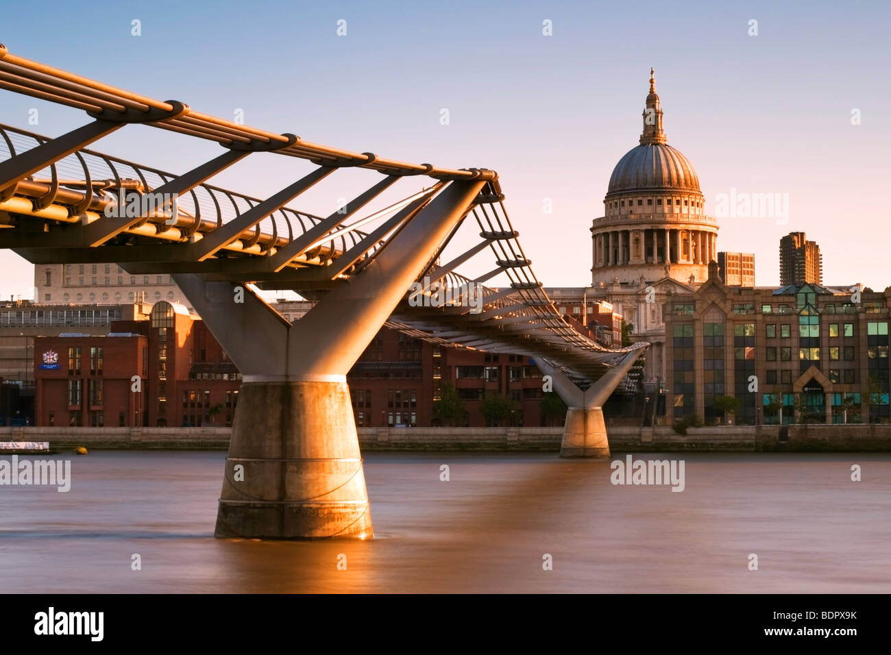 View of the Millennium Bridge with St Paul's Cathedral in the background and the financial district of the City of London Stock Photo