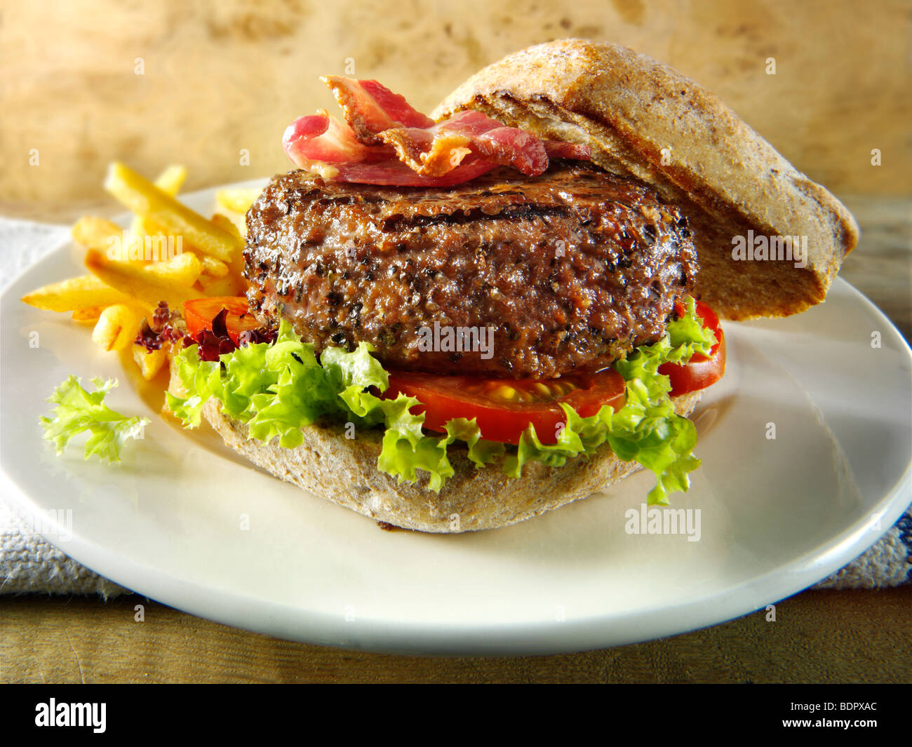 Peppered beef burger with chips Stock Photo