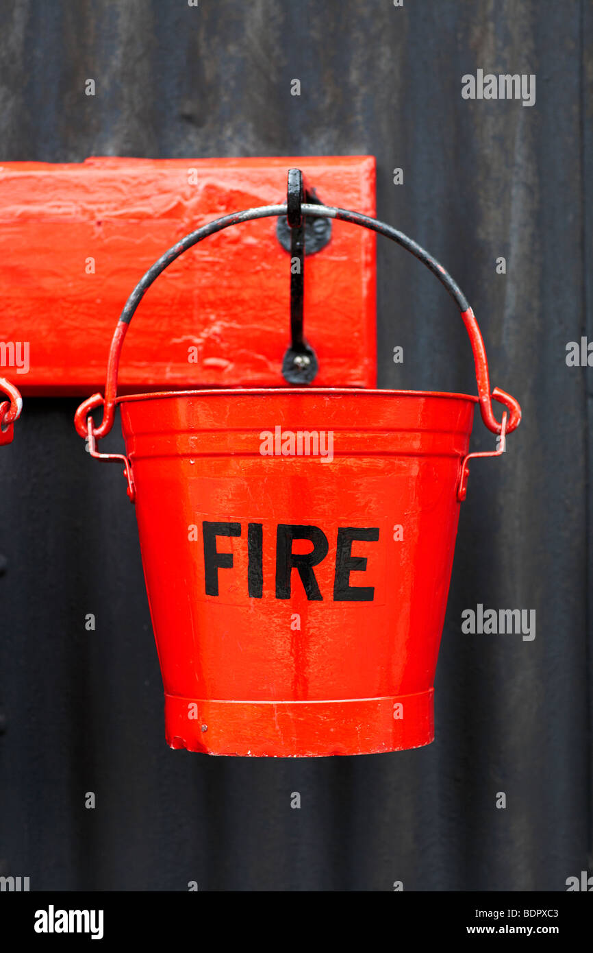 Fire Bucket, at a railway station. UK Stock Photo