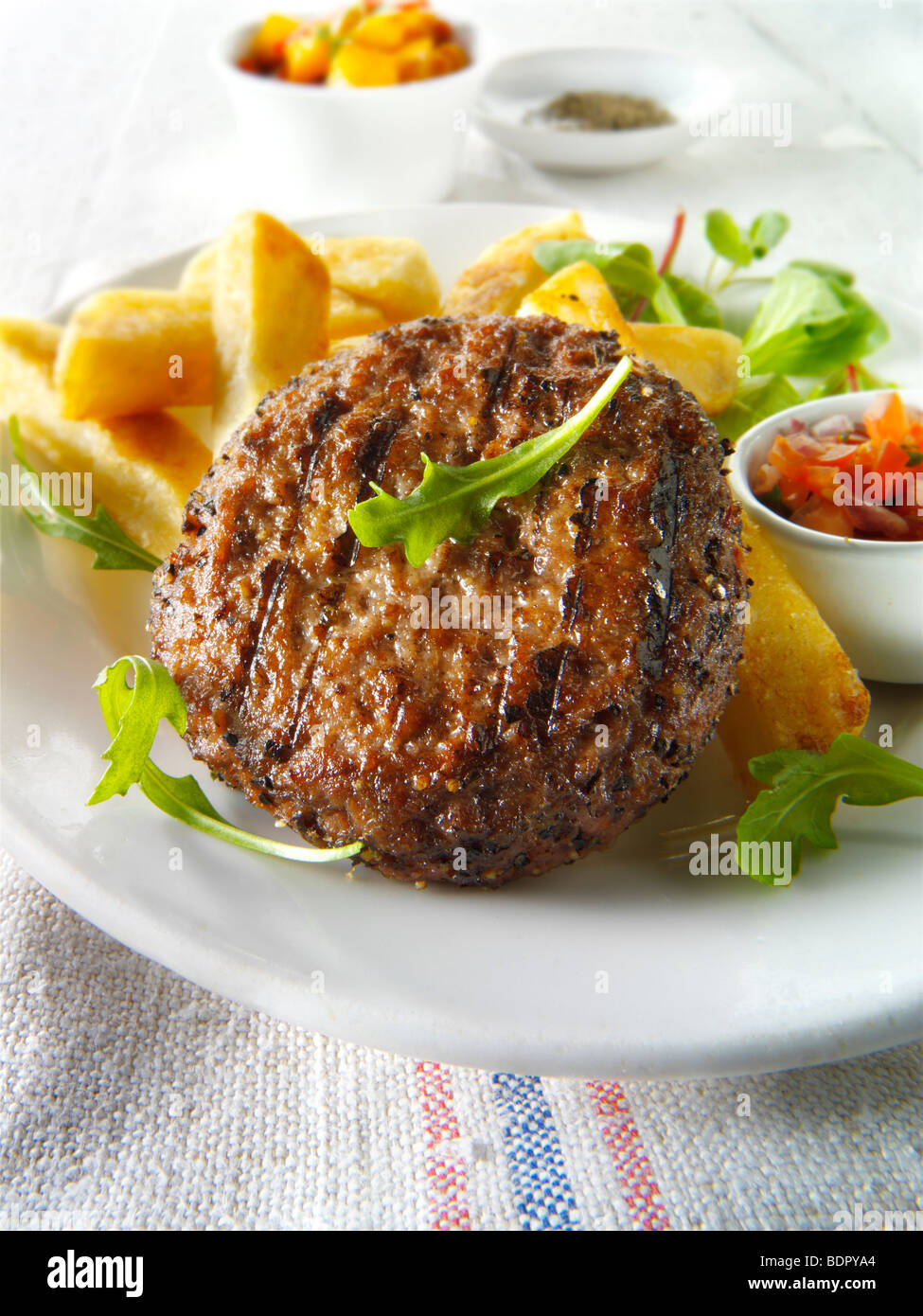 Char grilled beef burger with chunky chips and salad Stock Photo