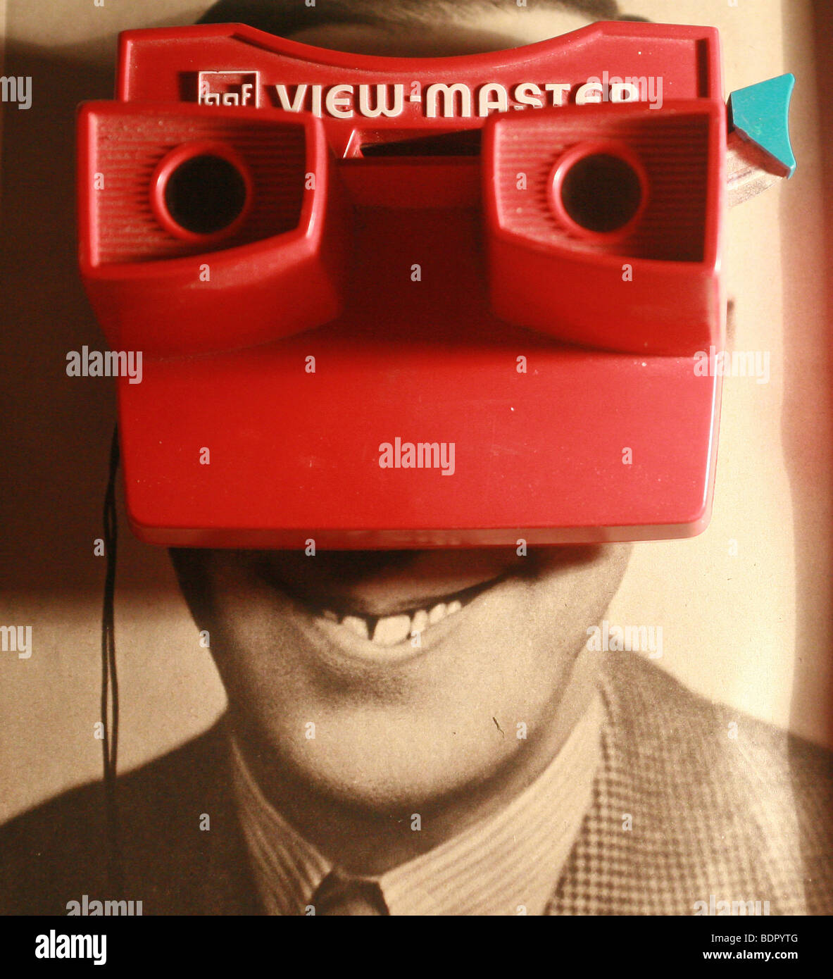 A smiling mans face behind a view master Stock Photo