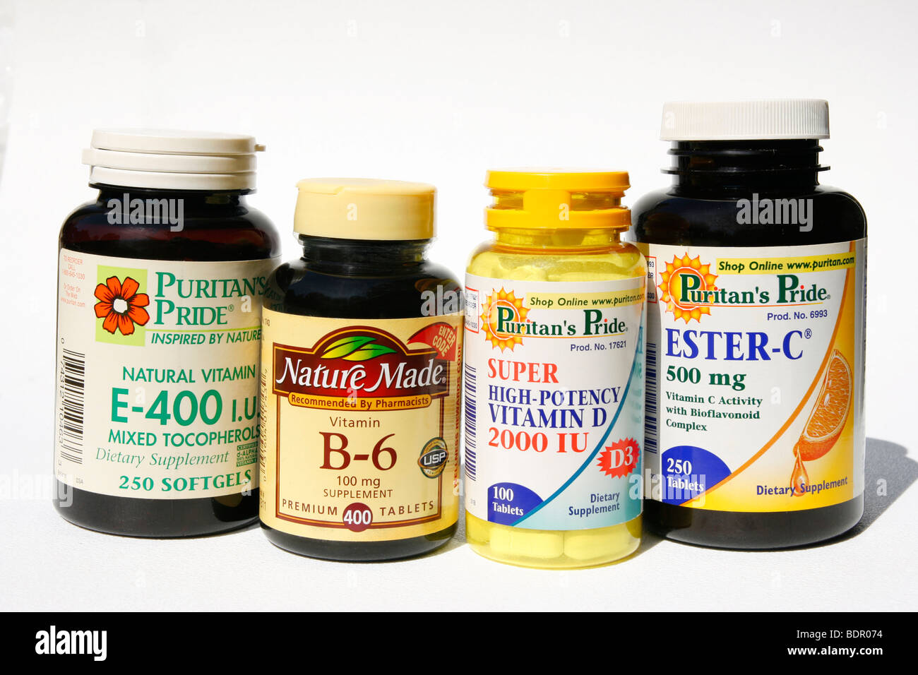 Bottles of vitamin supplements: E, B, D, and C. Stock Photo