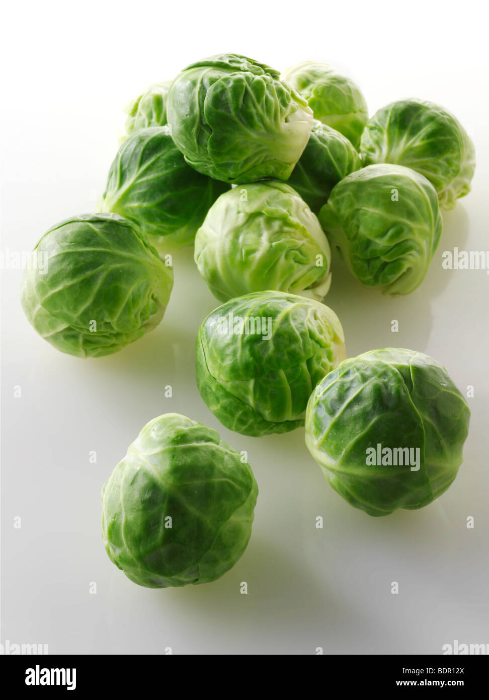 Fresh Brussels Sprouts against a white background Stock Photo