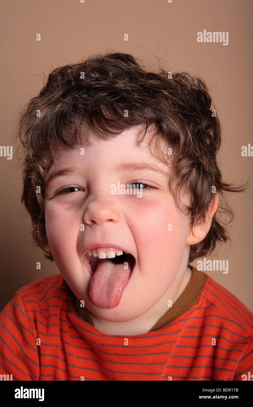 Young boy sticking out tongue Stock Photo Alamy