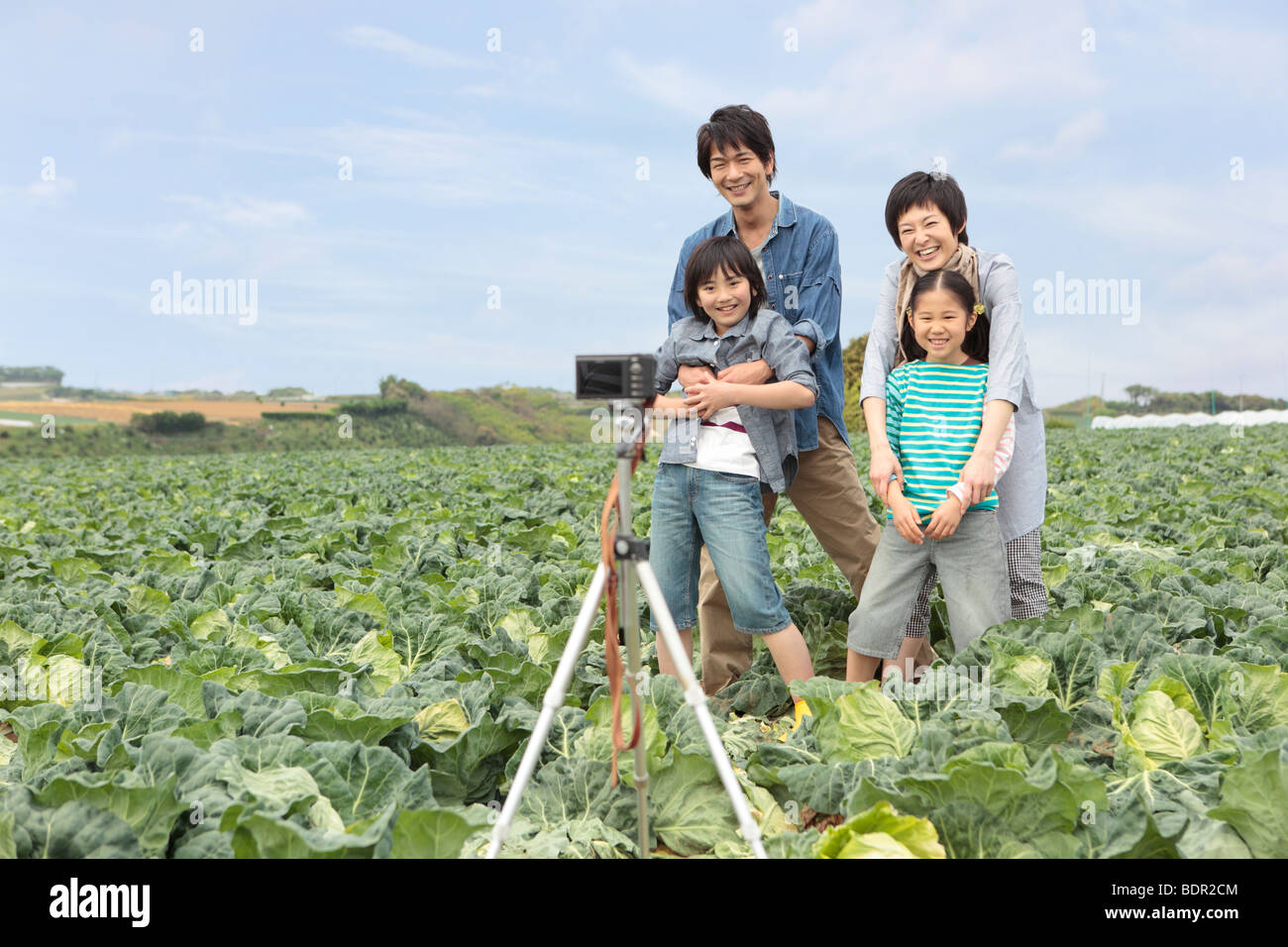 Family taking memorable photograph in field Stock Photo