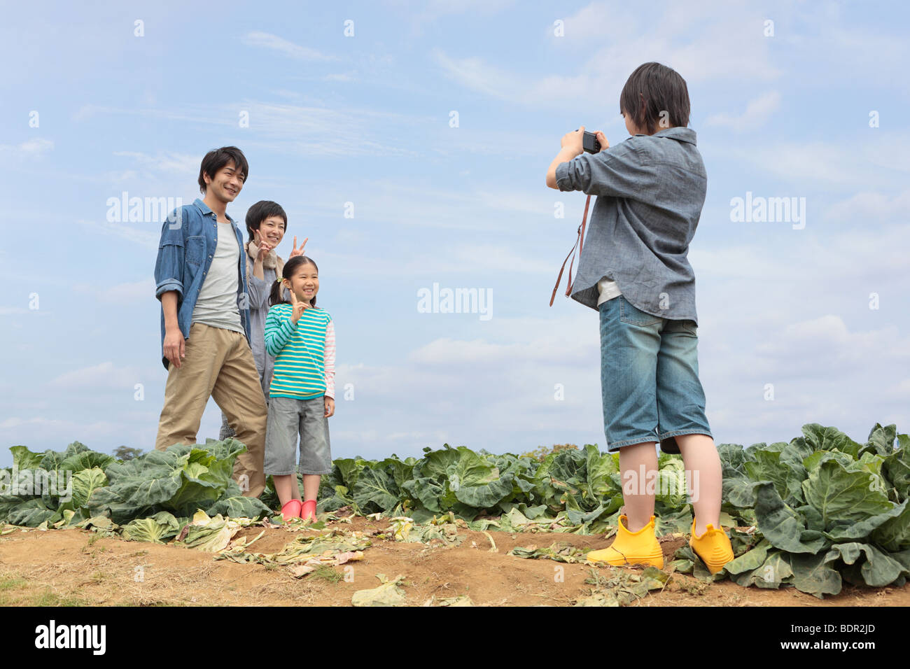 Family taking memorable photograph in field Stock Photo