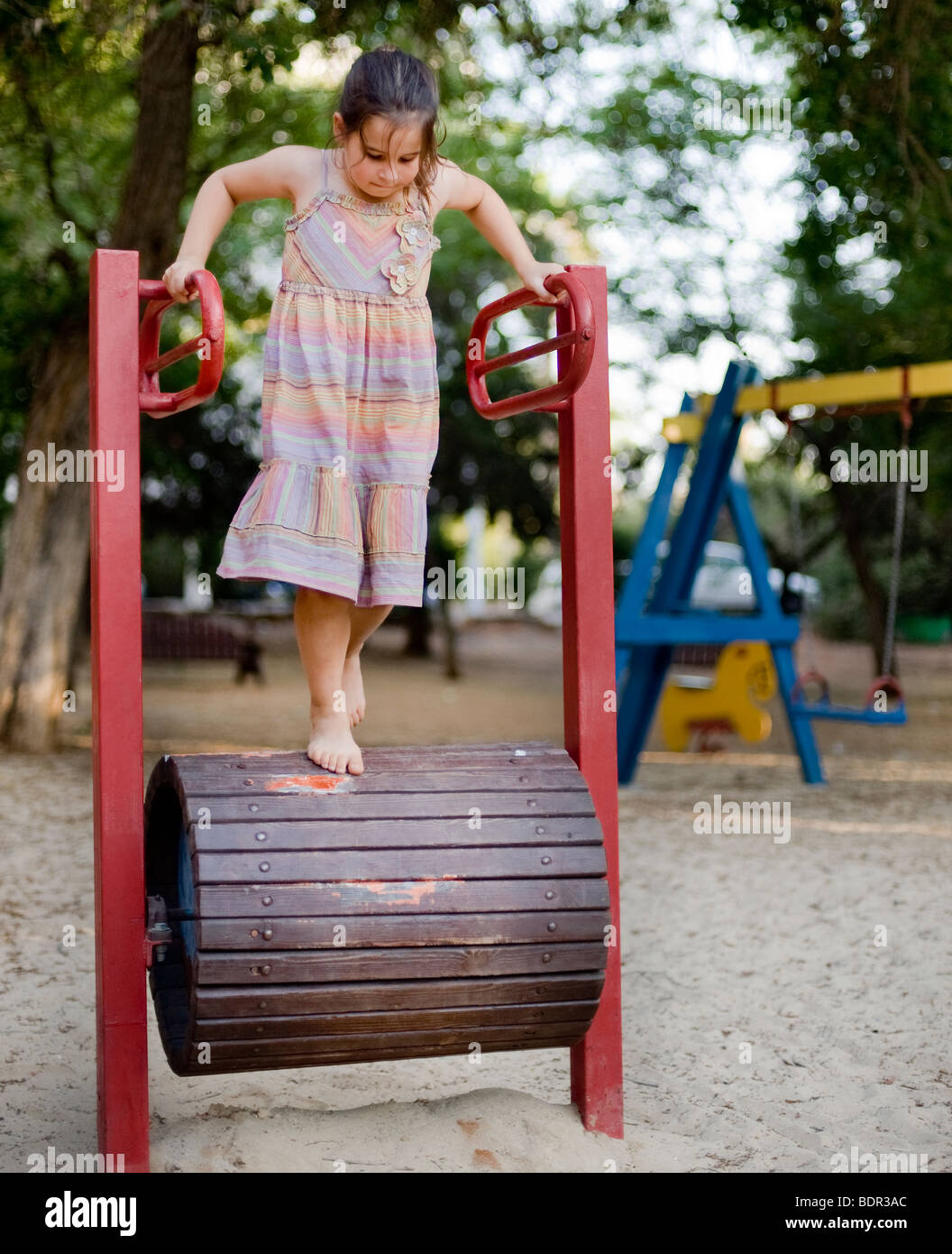 girl on a Walking Barrel in a playground Stock Photo Alamy