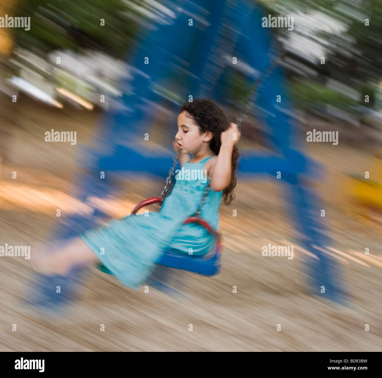 girl in blue dress on a swing with motion blur Stock Photo - Alamy