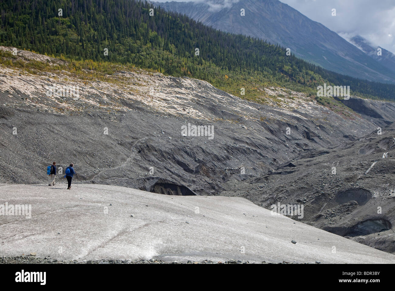 Kennicott, Alaska - A guide and a client hike on the Root Glacier in Wrangell-St. Elias National Park. Stock Photo