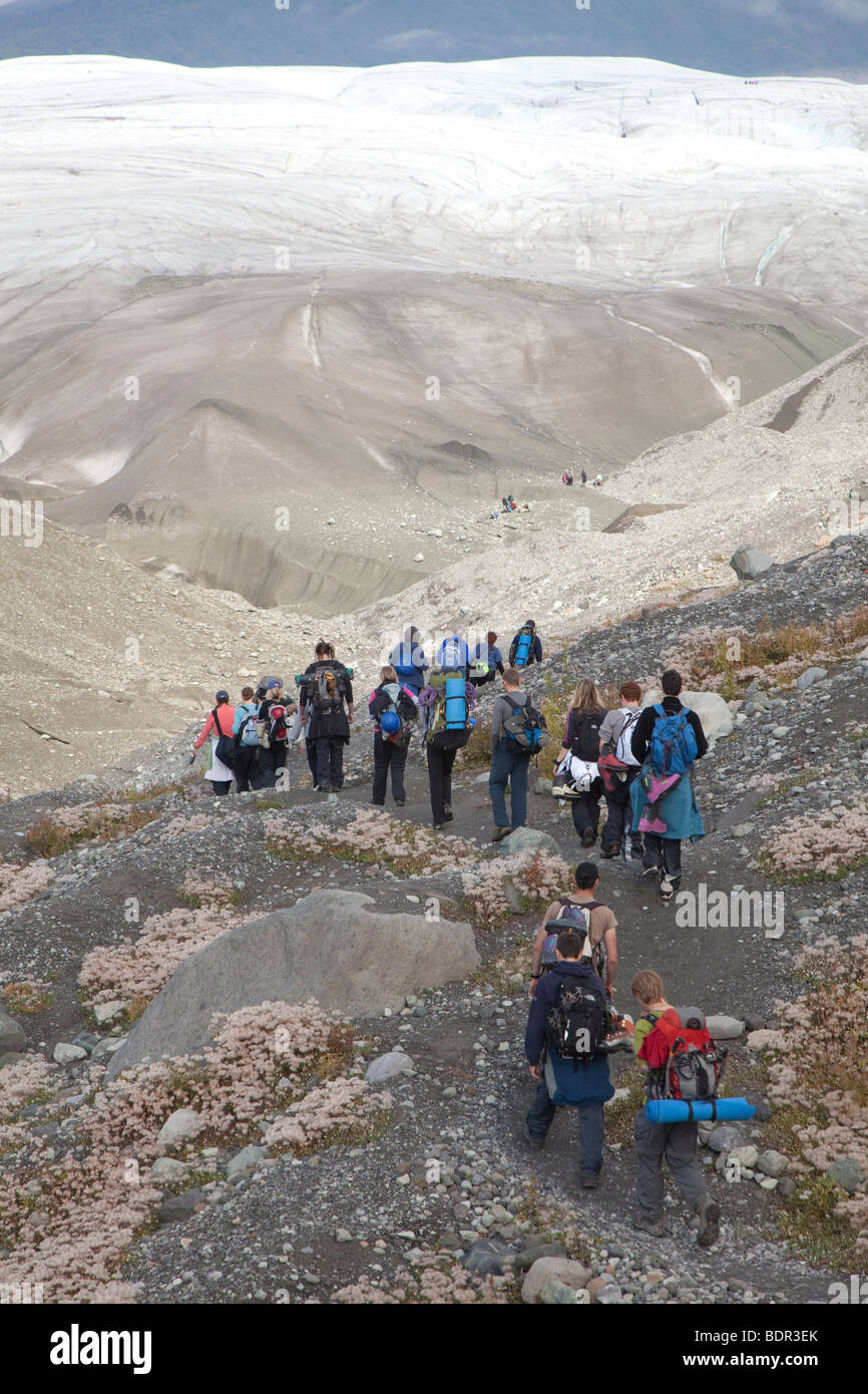 People hike towards Root Glacier in Wrangell-St. Elias National Park Stock Photo