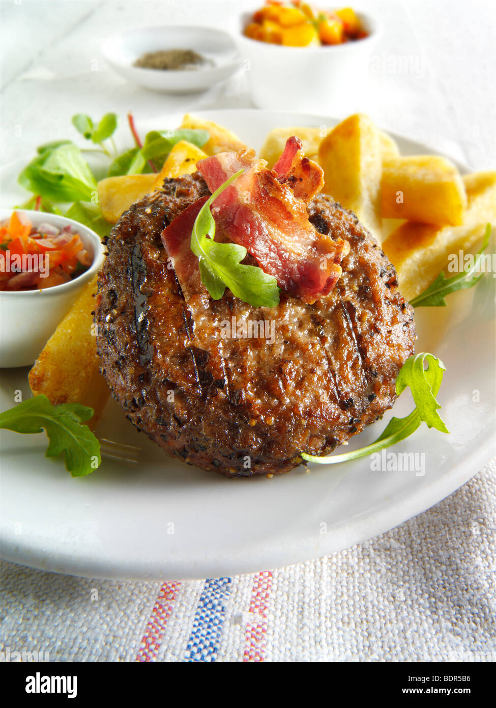 Char grilled beef burger with chunky chips and salad Stock Photo