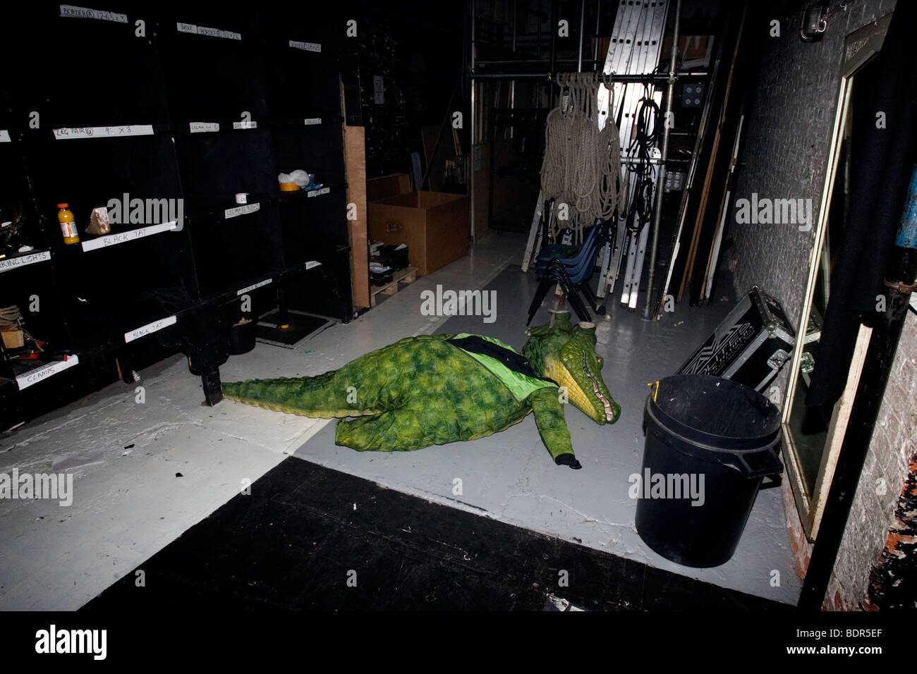 A crocodile costume is pictured laying on the floor backstage at the Theatre Royal, Brighton, East Sussex, UK. Stock Photo