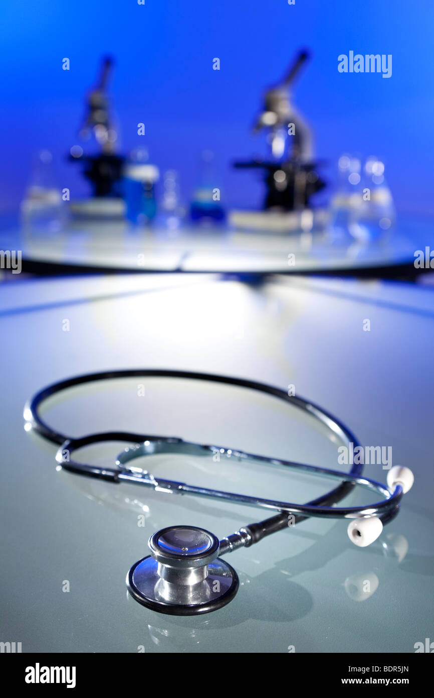 A stethoscope in a medical research laboratory with microscopes, flasks