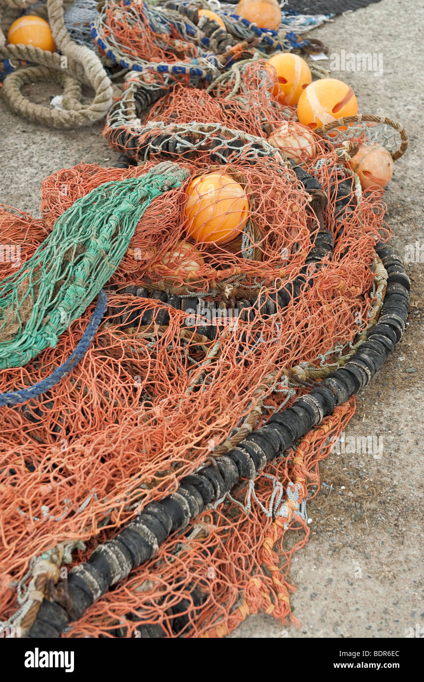 https://c8.alamy.com/comp/BDR6EC/close-up-of-bright-orange-sea-fishing-nets-with-attached-floats-piled-BDR6EC.jpg