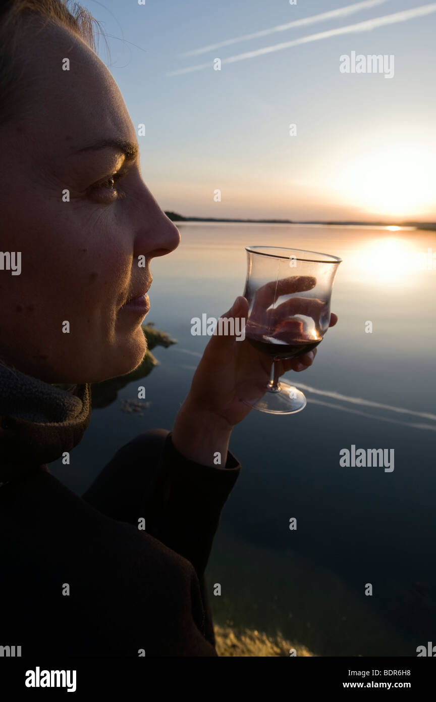 Woman holding glass of wine hi-res stock photography and images - Alamy