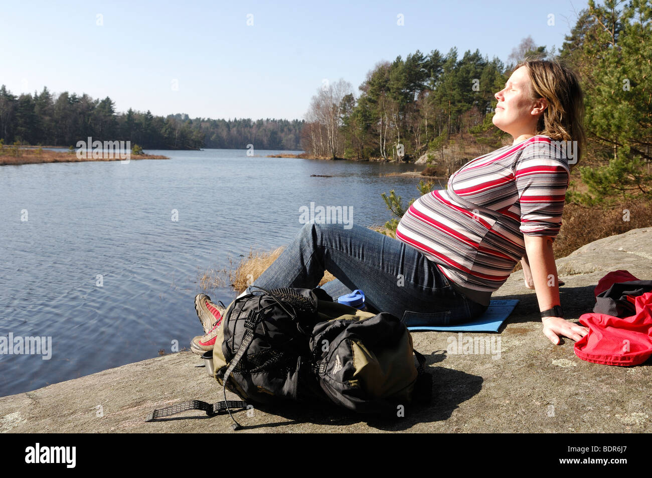 A pregnant woman by a lake Sweden. Stock Photo