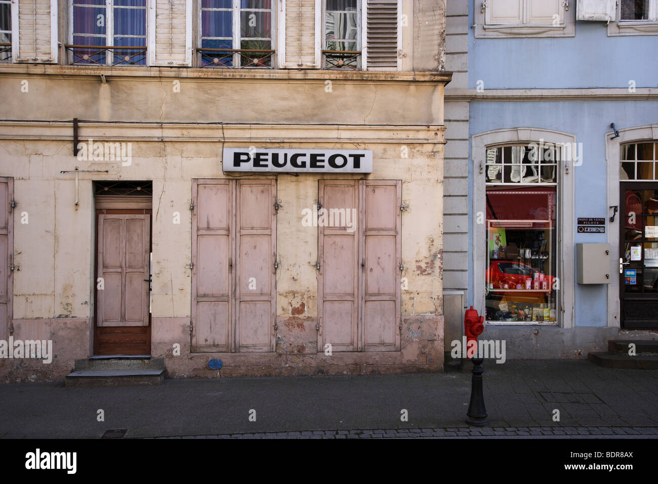 Old peugeot sign on house wall in Wissembourg Stock Photo