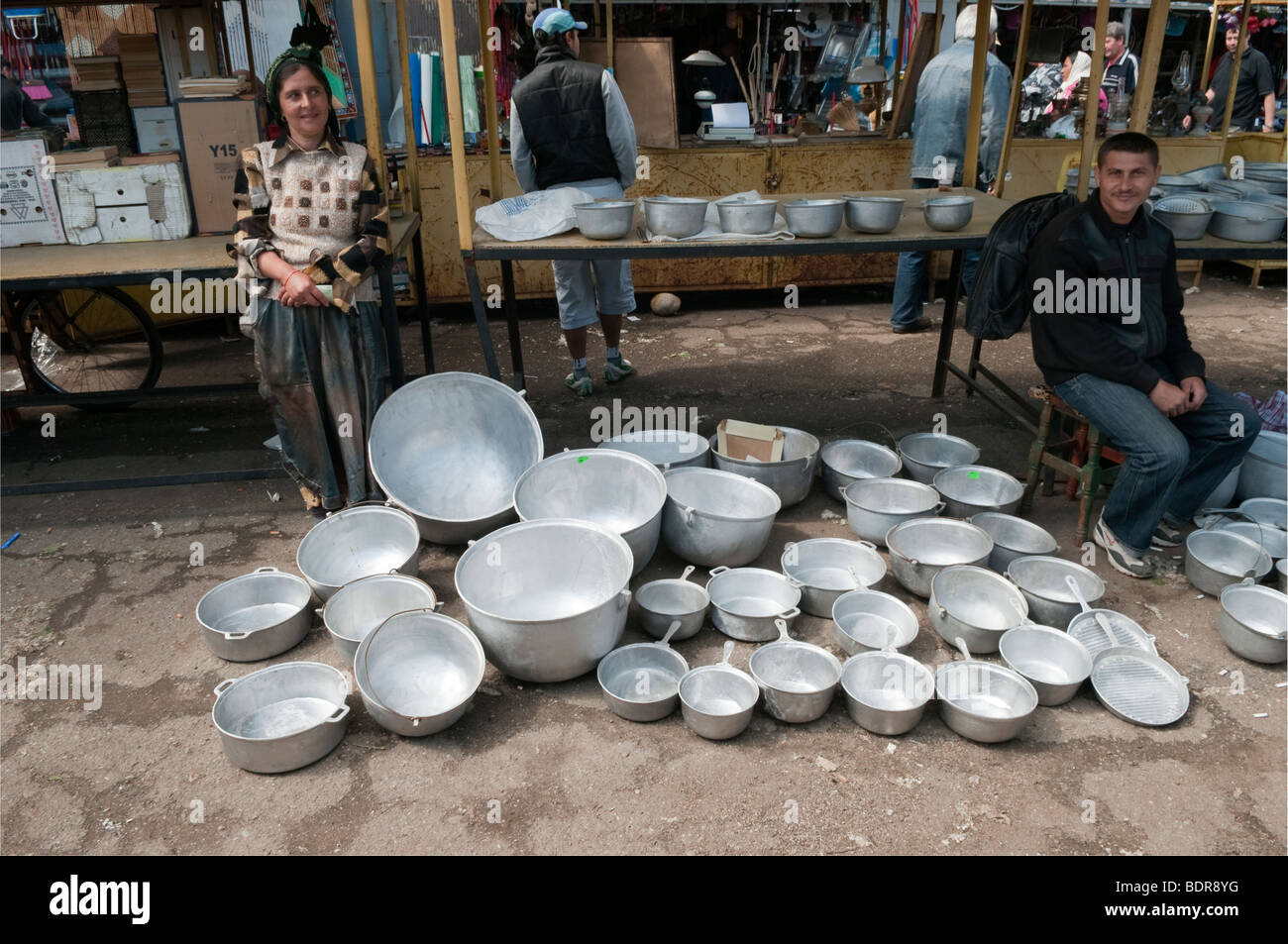 Woman selling aluminum pots and pans at market in Ploiesti Romania Eastern Europe Stock Photo