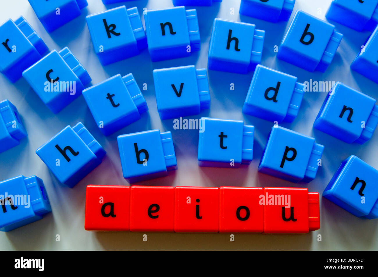 Vowels and Consonants.  Phonix red and blue cubes / bricks used to help children when learning to read. Stock Photo