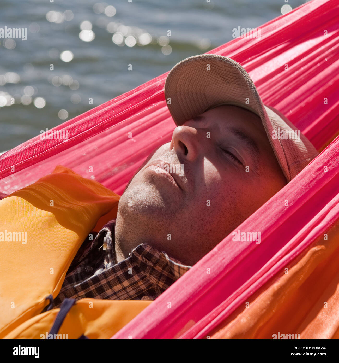 A man lying in a hammock Stock Photo