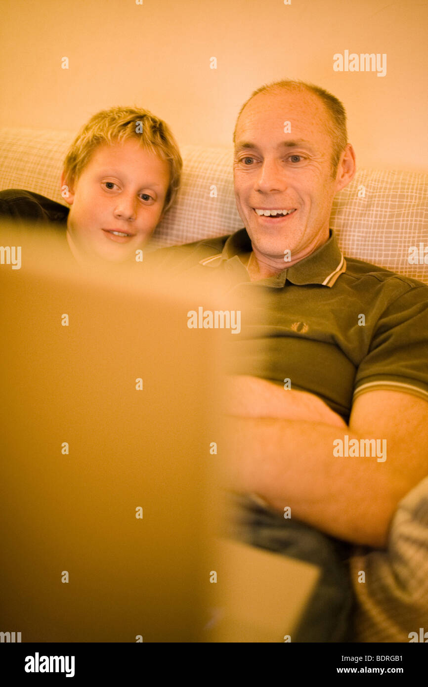 Father and son in front of a computer Stock Photo - Alamy