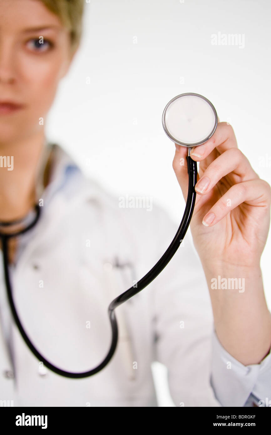 A female doctor listening into a stethoscope Stock Photo - Alamy