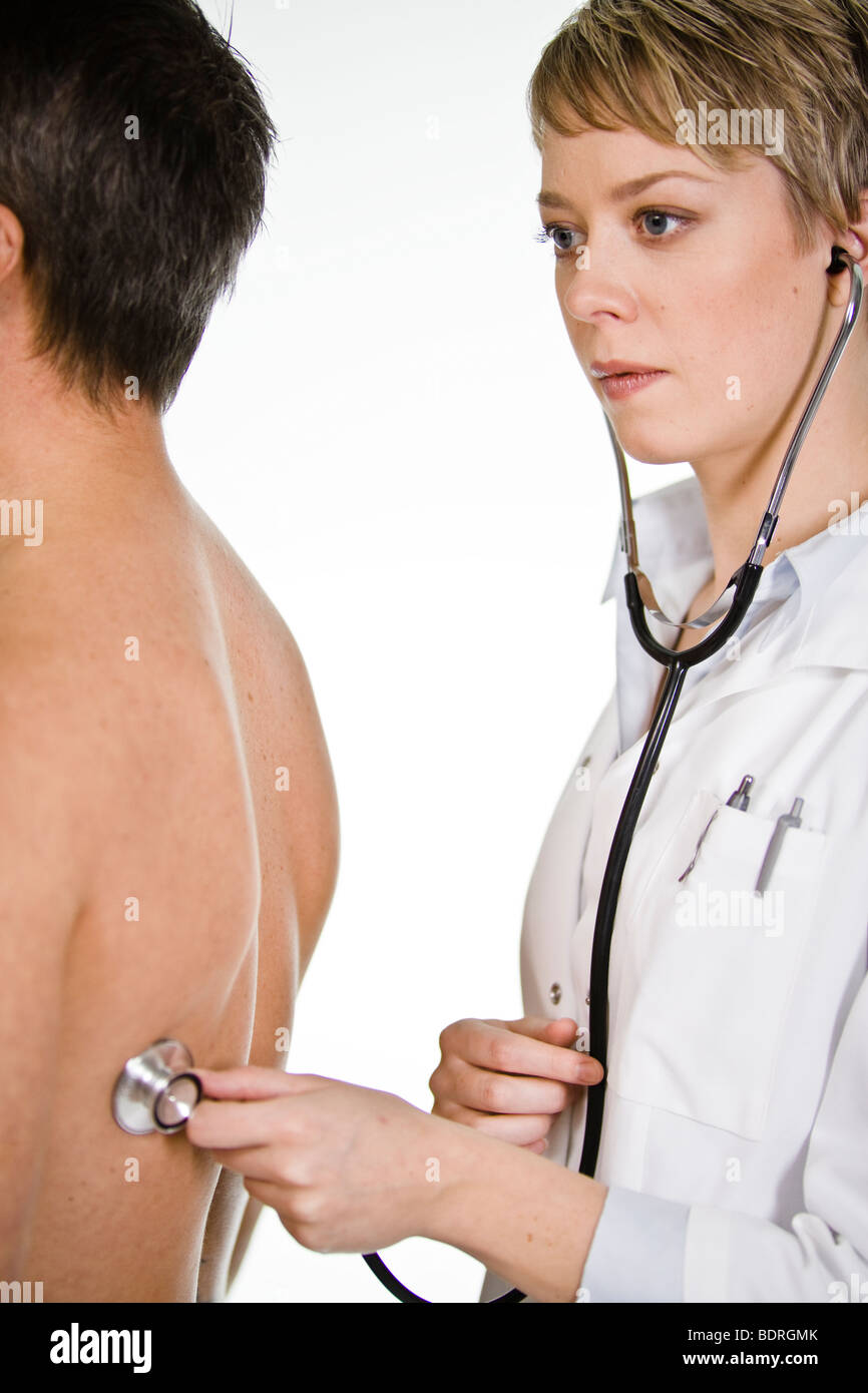 Female doctor using a stethoscope at a male patient Stock Photo - Alamy