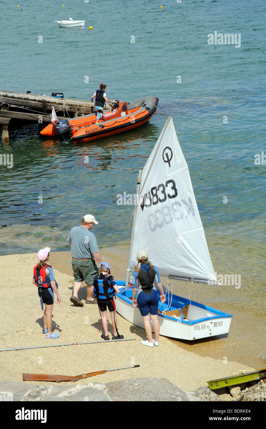 Young children launching their dinghy at Seaview near Bembridge Isle of