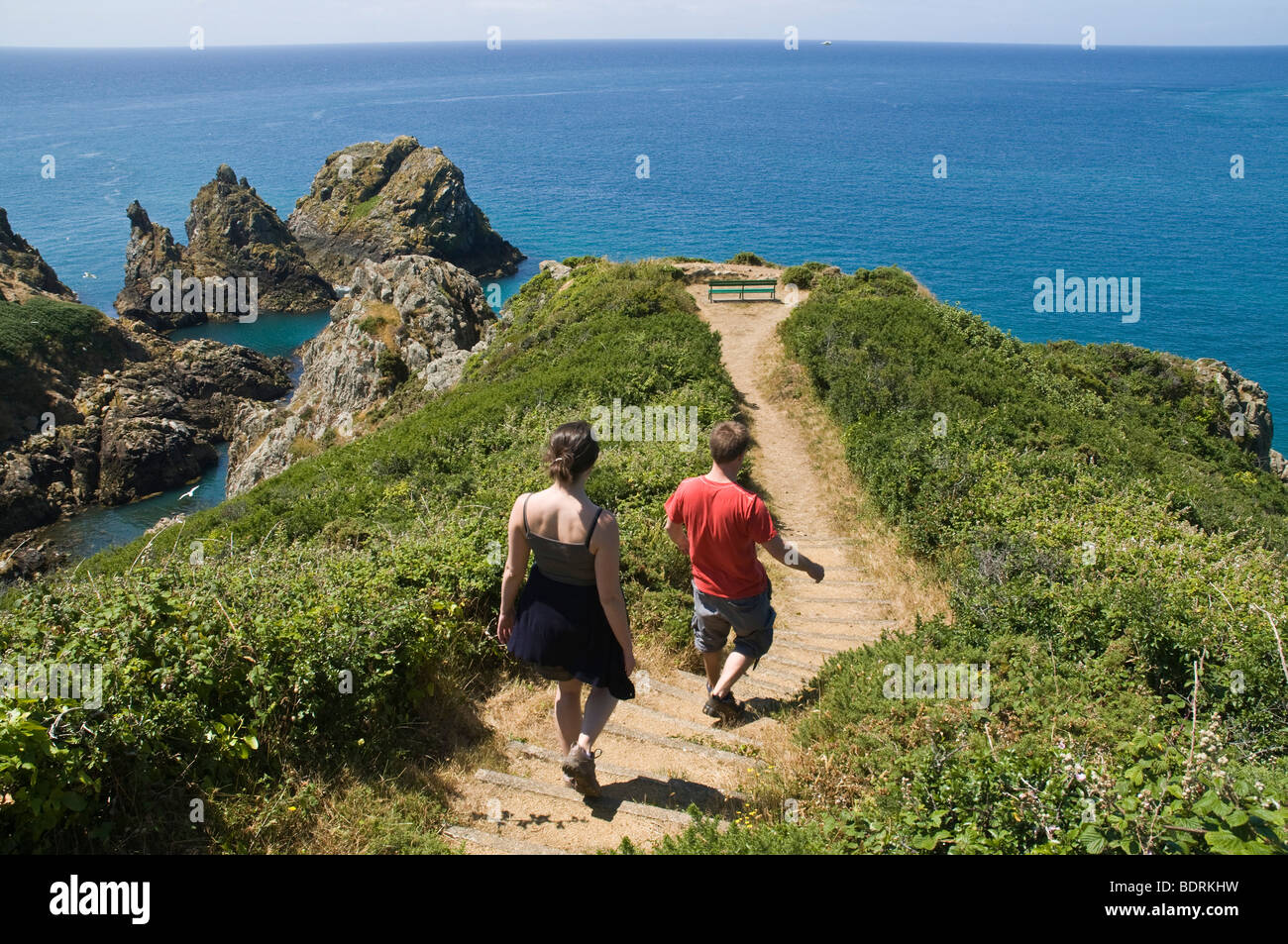 dh Jerbourg Point ST MARTIN GUERNSEY Young tourist couple footpath walkers cliff path walking coast walk people Stock Photo