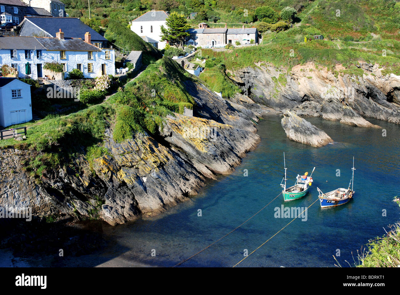 Two fishing boats at anchor in harbour, Portloe Cornwall England Stock Photo