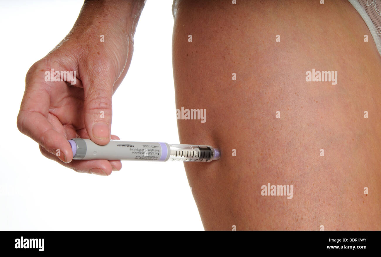 Woman injecting Insulin Stock Photo