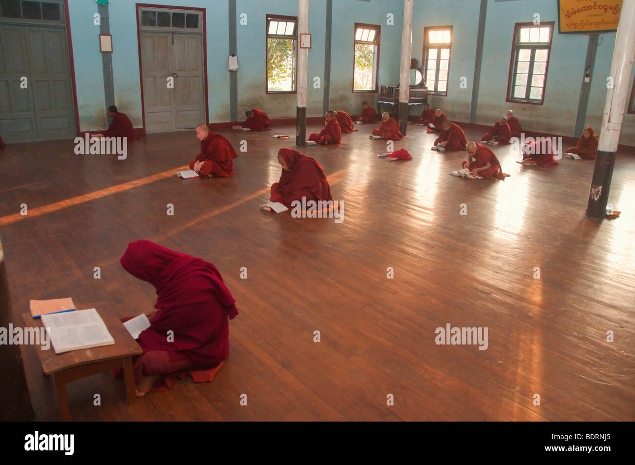 Monks in Prayer Robes at Evening Prayers at Theravada Buddhist Monastery in Kalaw, Shan State near Heho, Myanmar, Burma, Southea Stock Photo