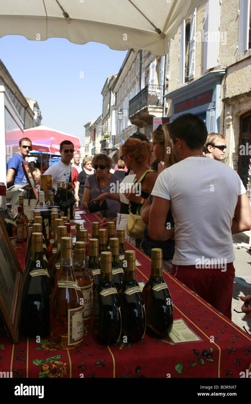 Stall with bottles of local wines and Armagnac at the weekly market in  Lectoure, France Stock Photo