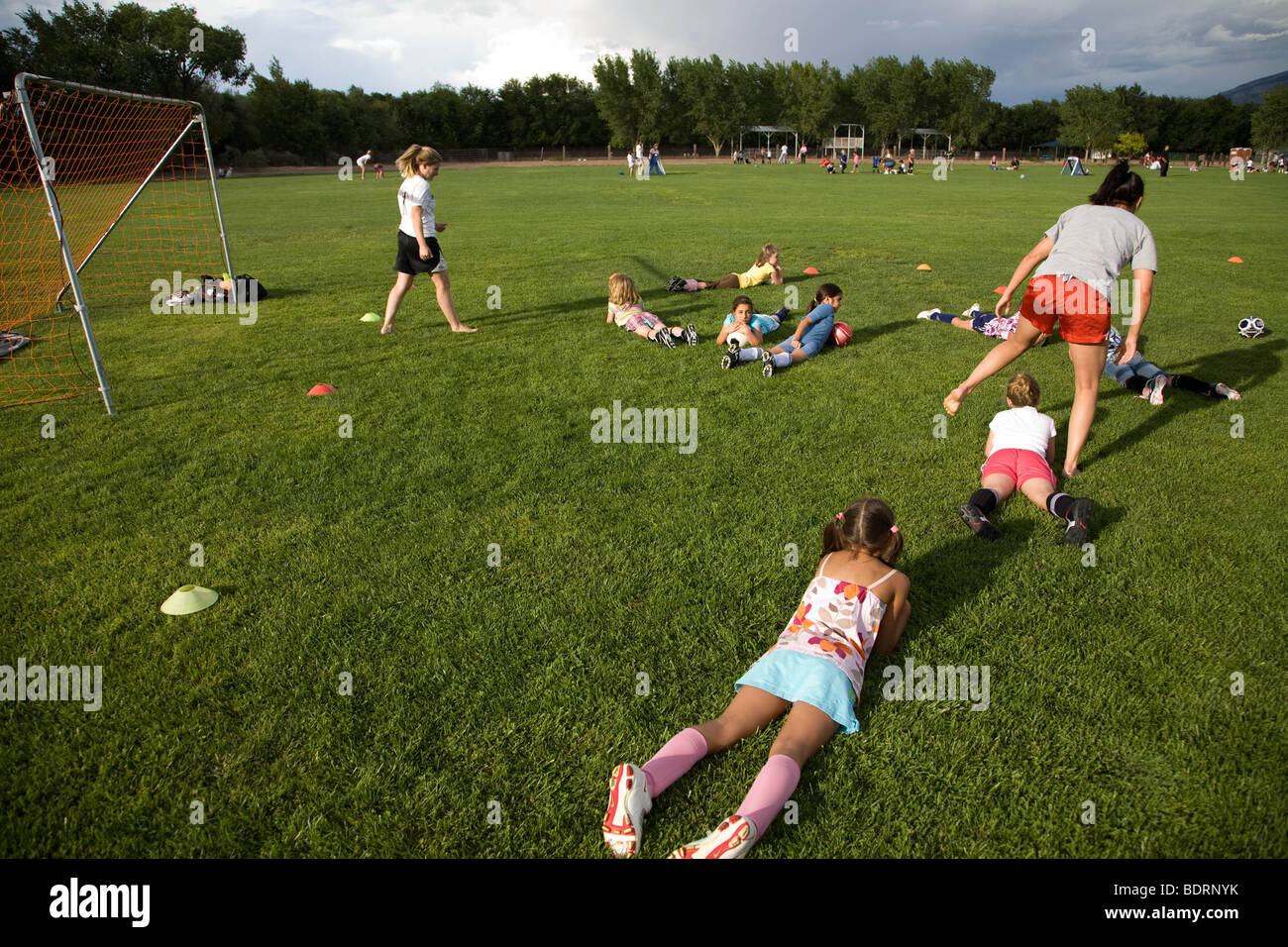 Girls getting training from soccer coach Stock Photo