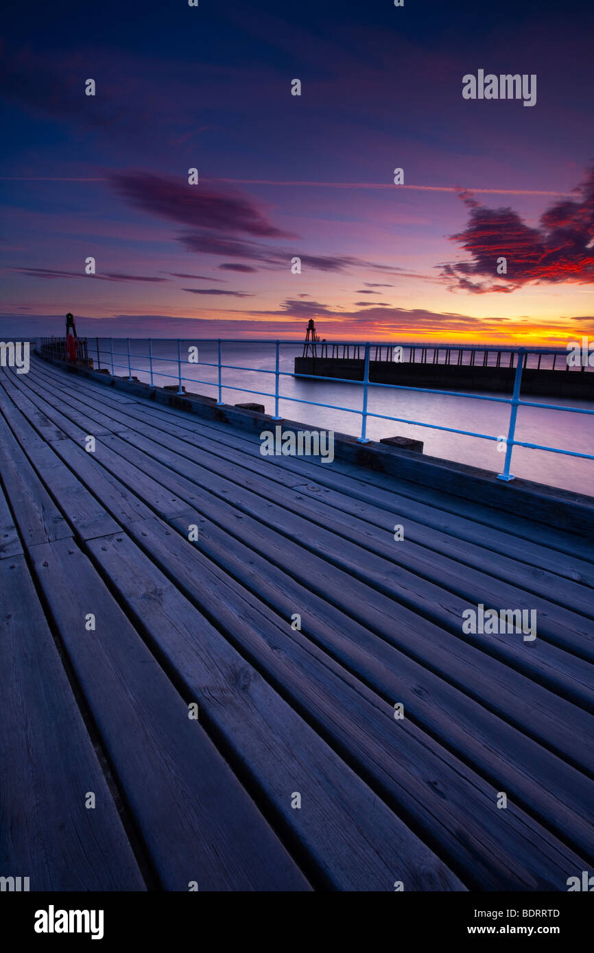 England, North Yorkshire, Whitby. The entrance piers of Whitby Harbour at dawn. Stock Photo