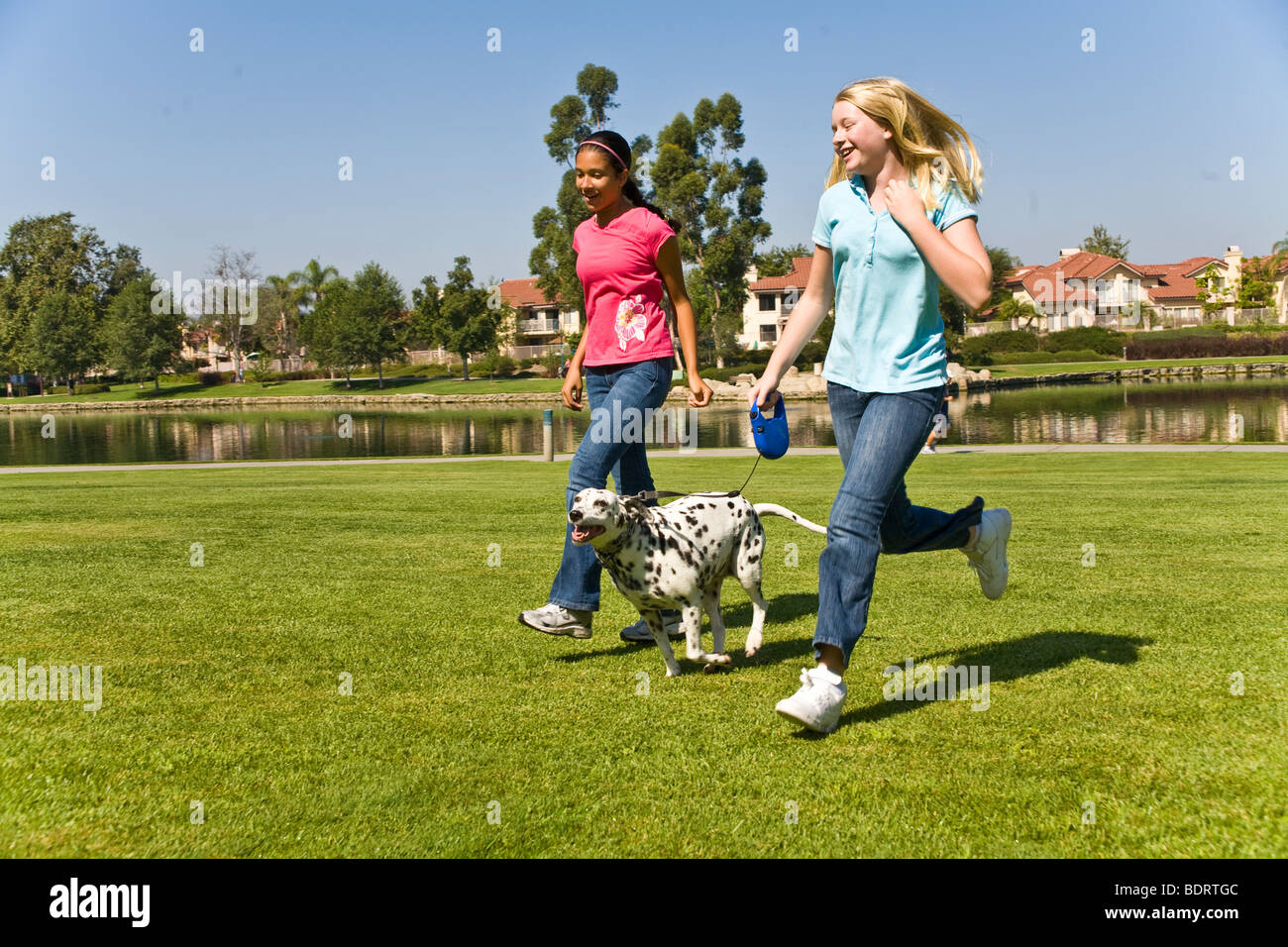 Dog owner 11-13 year years old running multicultural multi mix diversity Hispanic Caucasian Tween tweens spotty healthy front side view USA  © Myrleen Pearson Stock Photo