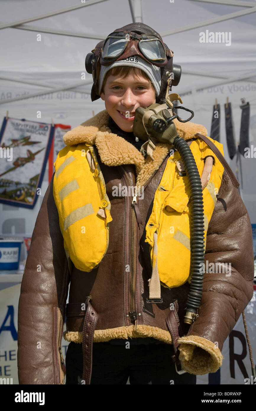 Young boy wearing WW2 pilots leather flight suit, life vest and helmet with  goggles Stock Photo - Alamy