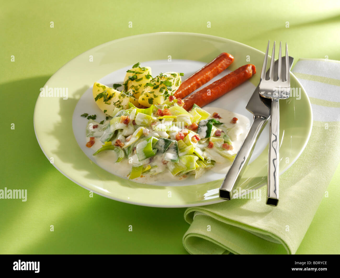 Leek vegetables with potatoes, bacon and Debreziner sausage Stock Photo