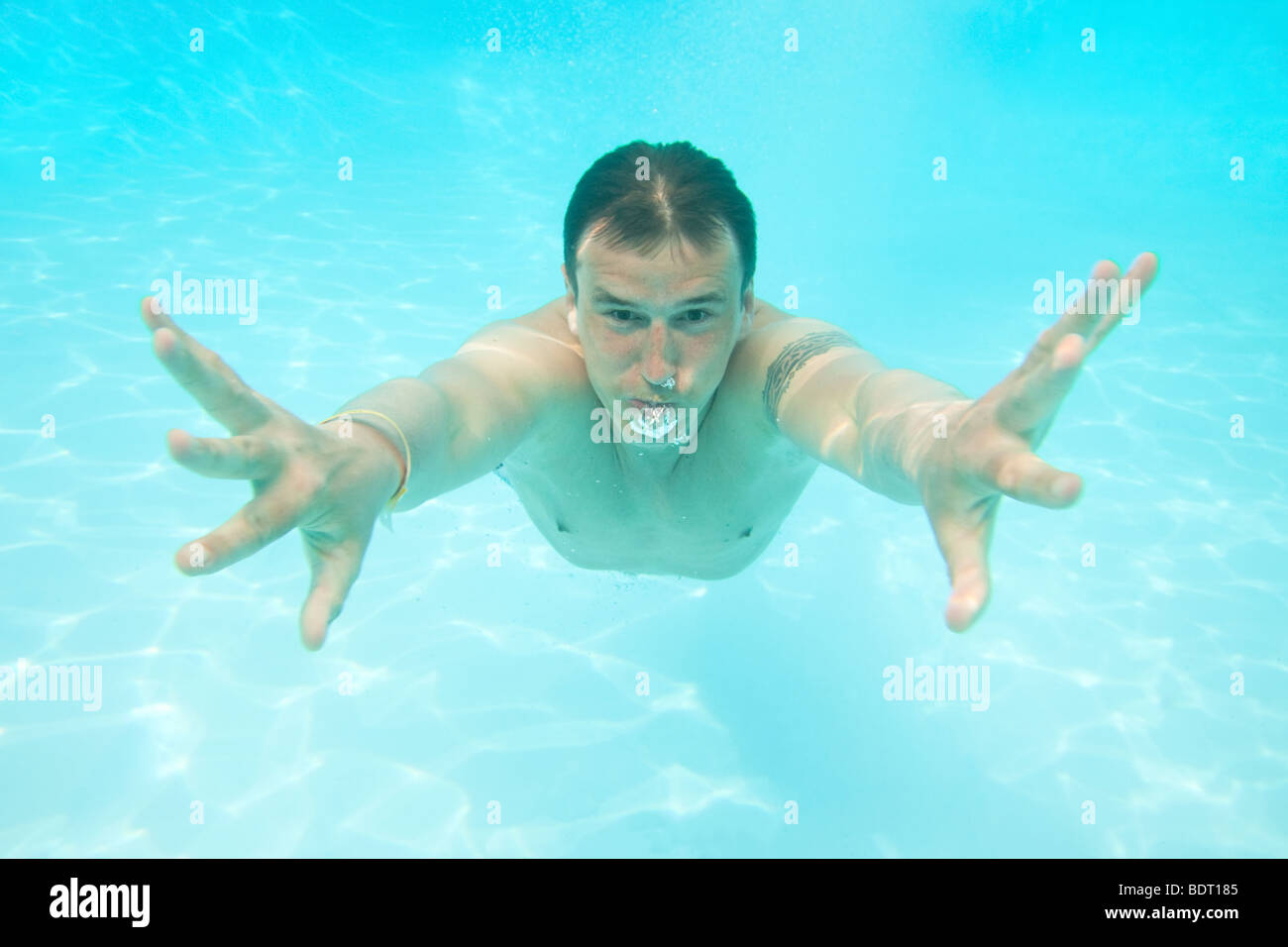 Man swimming under water Stock Photo