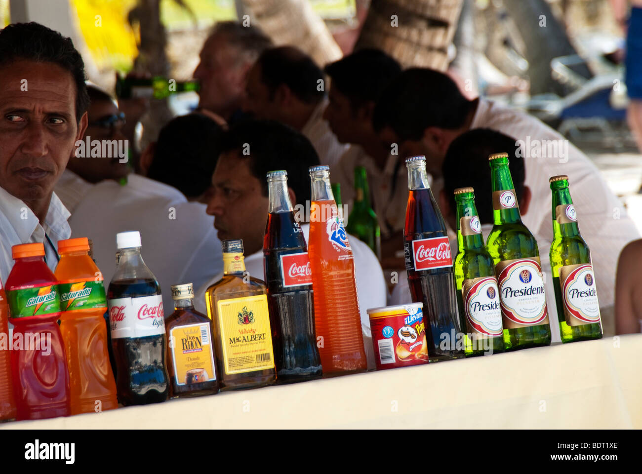 Soft drinks, beer and spirits lined up on a beach bar. Stock Photo