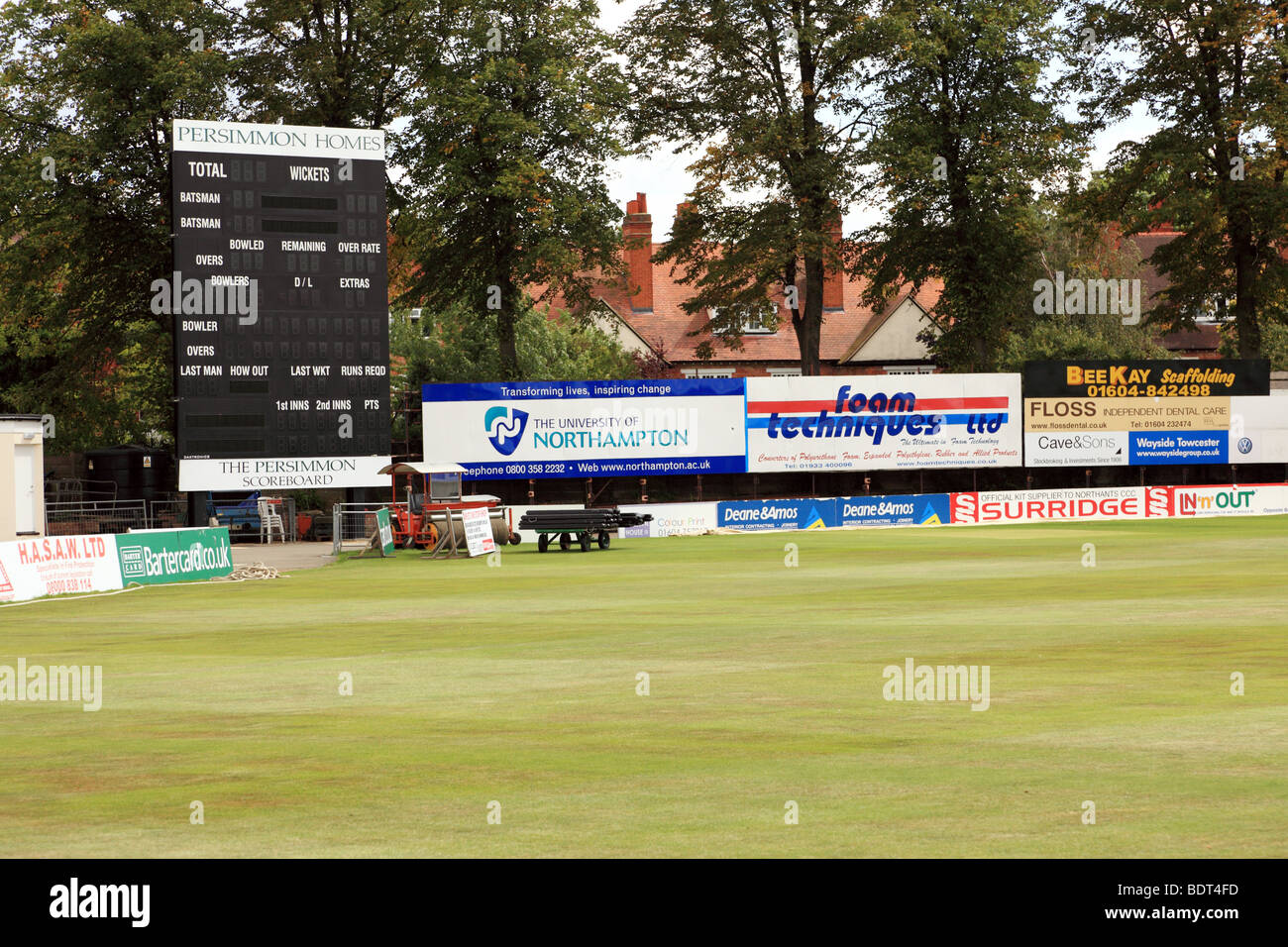A cricket scoreboard with advertising banners Stock Photo